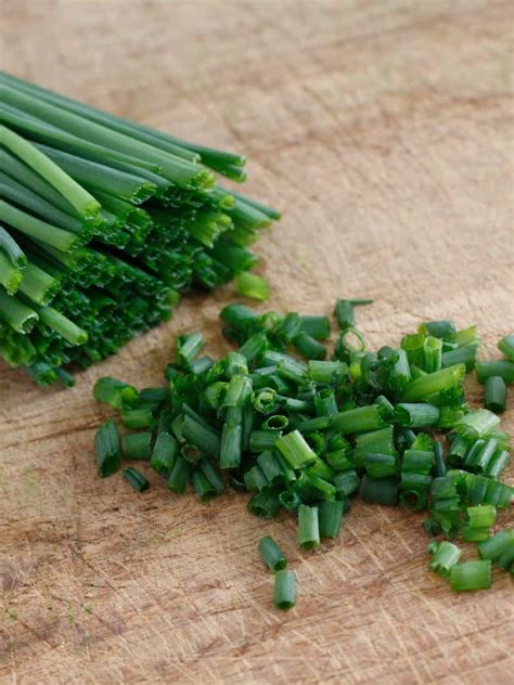 Thematic photo of fresh chives in a kitchen setting or growing in a garden