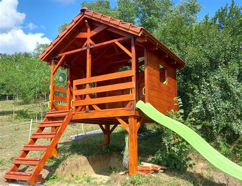 Ilustračná fotografia rôznych detských záhradných domčekov so šmykľavkou, ktoré evokujú radosť a dobrodružstvo.