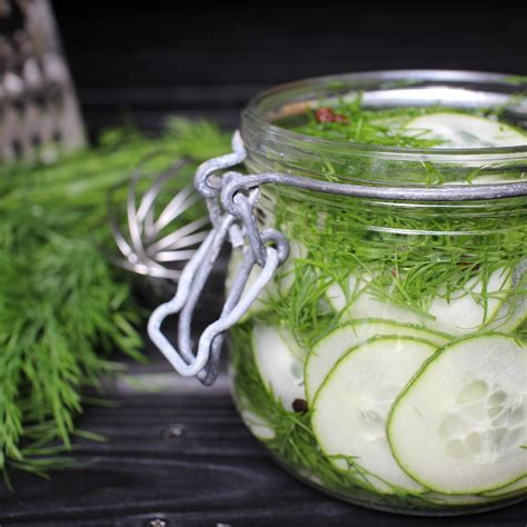 Fotografia sklenenej nádoby s fermentovaným cesnakom v octe a bylinkami.