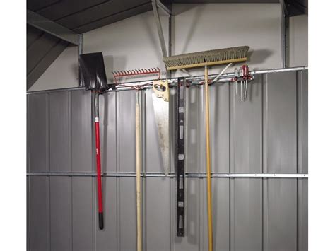 Fotografia záhradného náradia na starostlivosť o záhon a fľaša s náterom na drevo